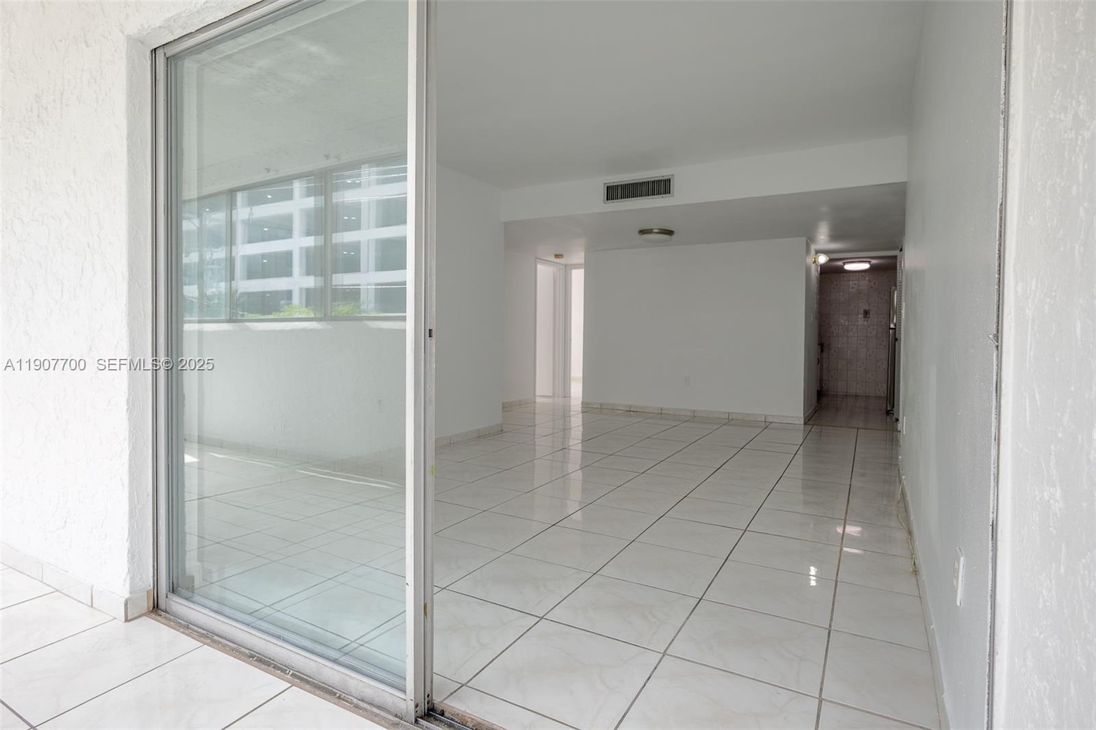 750 Northwest 43rd Avenue, Unit 308 Miami, FL 33126 - Photo 14 of 31 a view of an empty room with a glass door