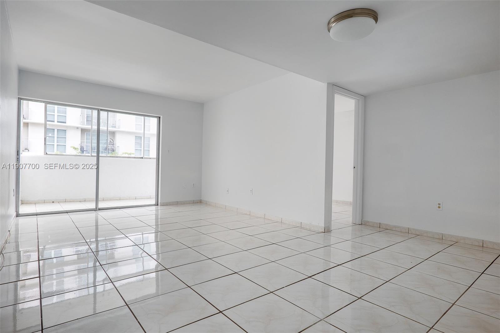 750 Northwest 43rd Avenue, Unit 308 Miami, FL 33126 - Photo 19 of 31 a view of an empty room with a window