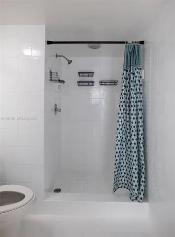 a bathroom with a bathtub and shower