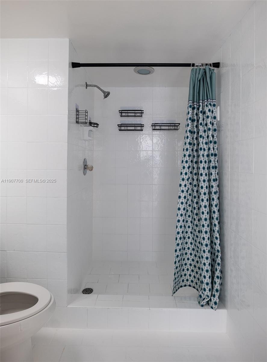 750 Northwest 43rd Avenue, Unit 308 Miami, FL 33126 - Photo 23 of 31 a bathroom with a bathtub and shower