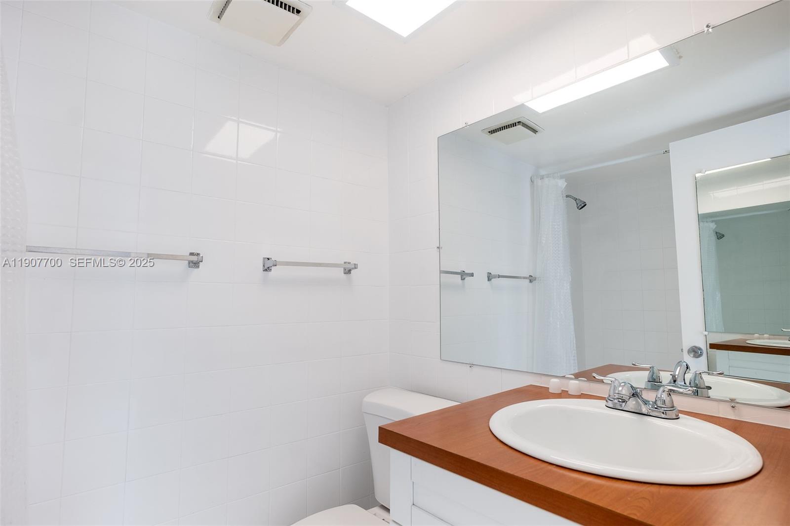 750 Northwest 43rd Avenue, Unit 308 Miami, FL 33126 - Photo 28 of 31 a bathroom with a sink and a mirror