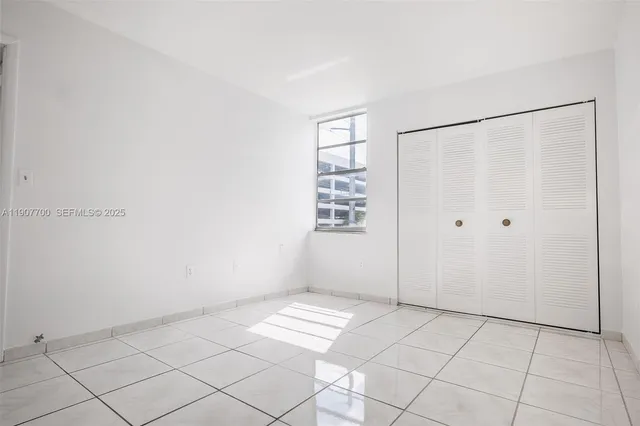 a bathroom with a granite countertop sink mirror vanity and toilet