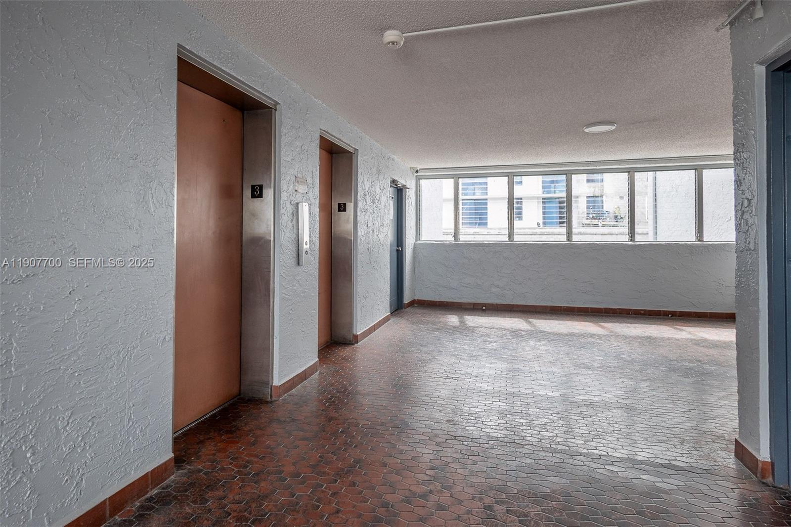 750 Northwest 43rd Avenue, Unit 308 Miami, FL 33126 - Photo 6 of 31 an empty room with windows