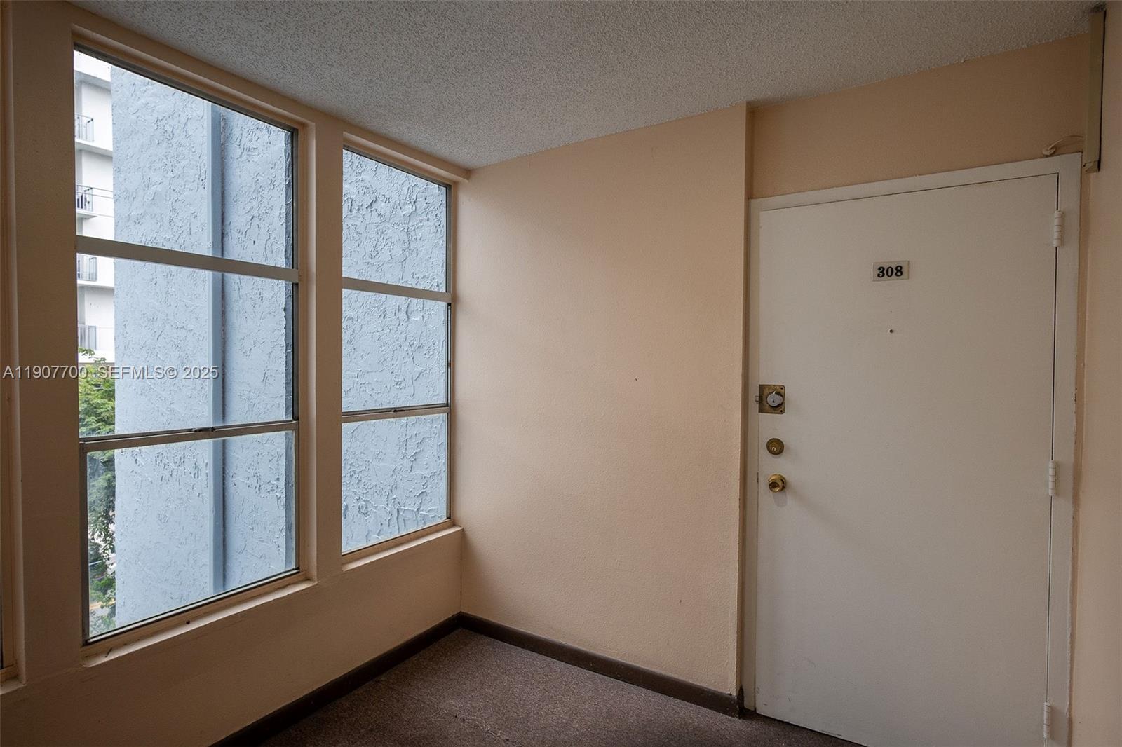 750 Northwest 43rd Avenue, Unit 308 Miami, FL 33126 - Photo 7 of 31 a view of empty room with window