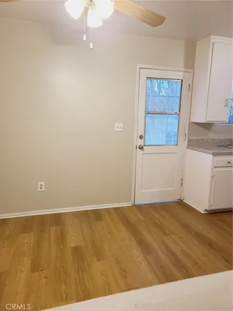a kitchen with granite countertop a stove a sink and a refrigerator