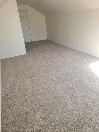 a view of a kitchen with white cabinets