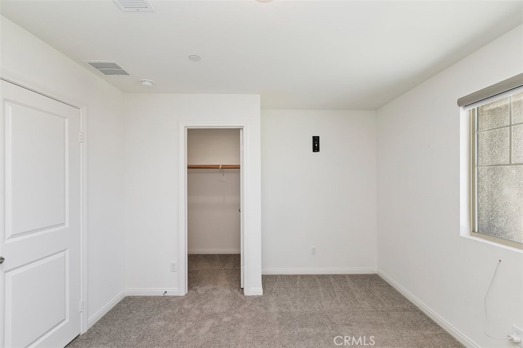 4521 Highland Avenue Perris, CA 92571 - Photo 32 of 54 an empty room with windows and closet