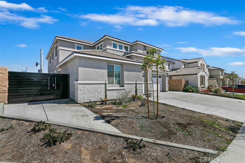 4521 Highland Avenue Perris, CA 92571 - Photo 4 of 54 a front view of a house with parking space