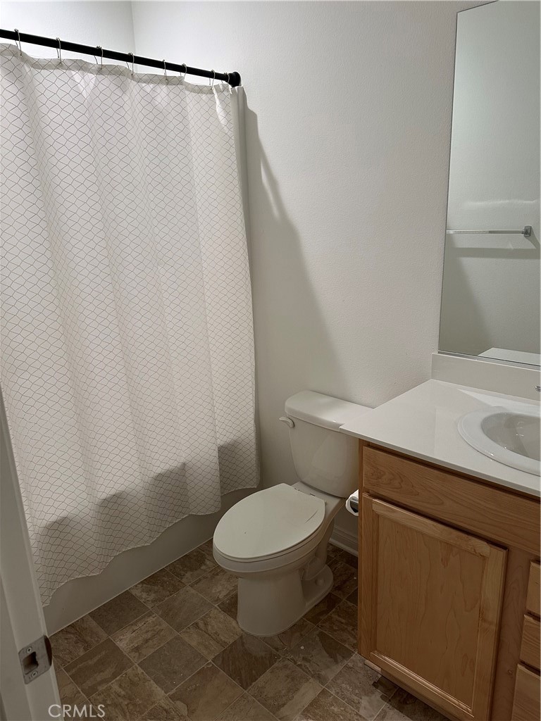 4521 Highland Avenue Perris, CA 92571 - Photo 48 of 54 a white toilet sitting next to a shower