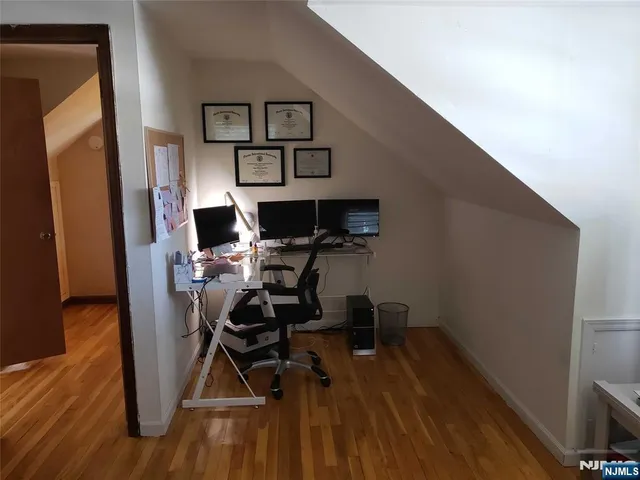 a view of a workspace with furniture and wooden floor
