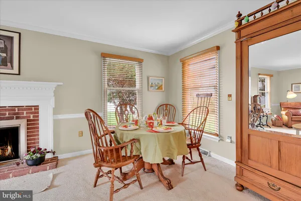 a view of a dining room with furniture and a fireplace