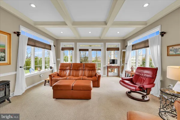 a living room with furniture gym equipment and a large window