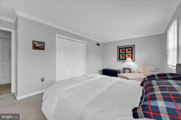 a bedroom with double bed and a window
