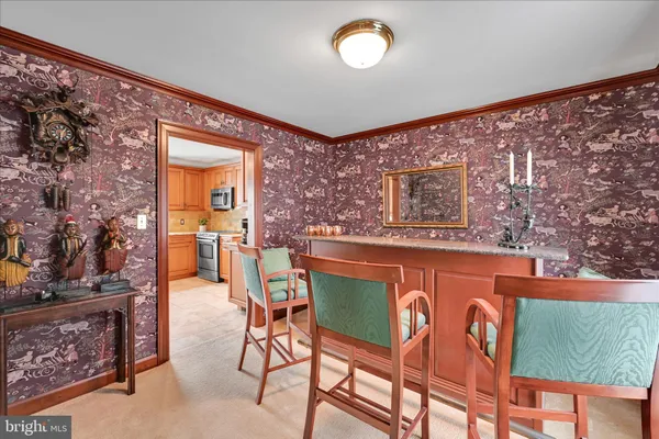 a dining room with furniture and a floor to ceiling window