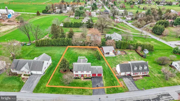 an aerial view of residential houses with outdoor space and street view