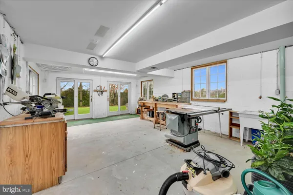 a room with patio furniture and potted plants