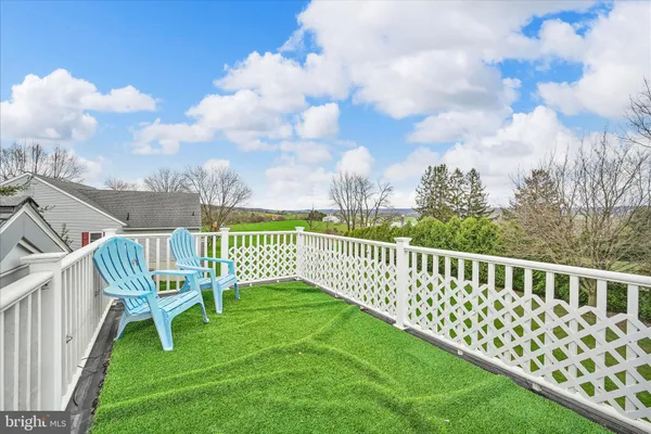 a view of a deck with a yard