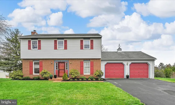 a front view of brick house with a yard