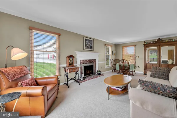 a living room with furniture a window and a fireplace