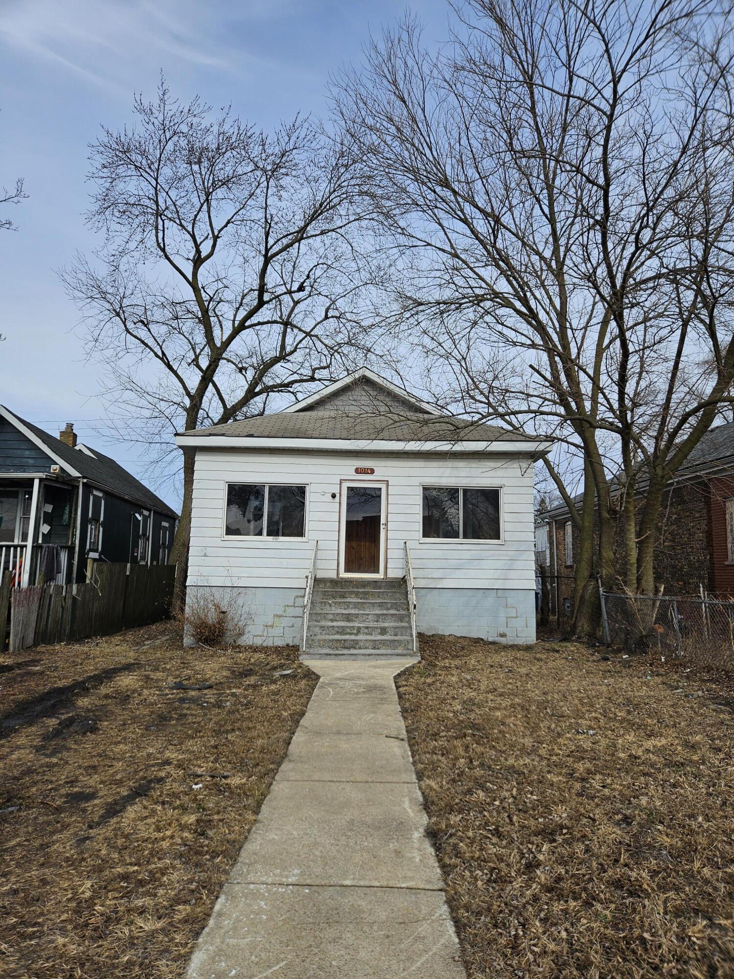 a front view of house with yard and trees