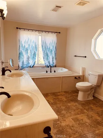 a bathroom with a double vanity sink and mirror