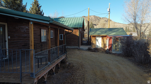 348 North Jakes Pl Road Loa, UT 84747 - Photo 4 of 26 View of side of home with a metal roof, an outbuilding, and a mountain view