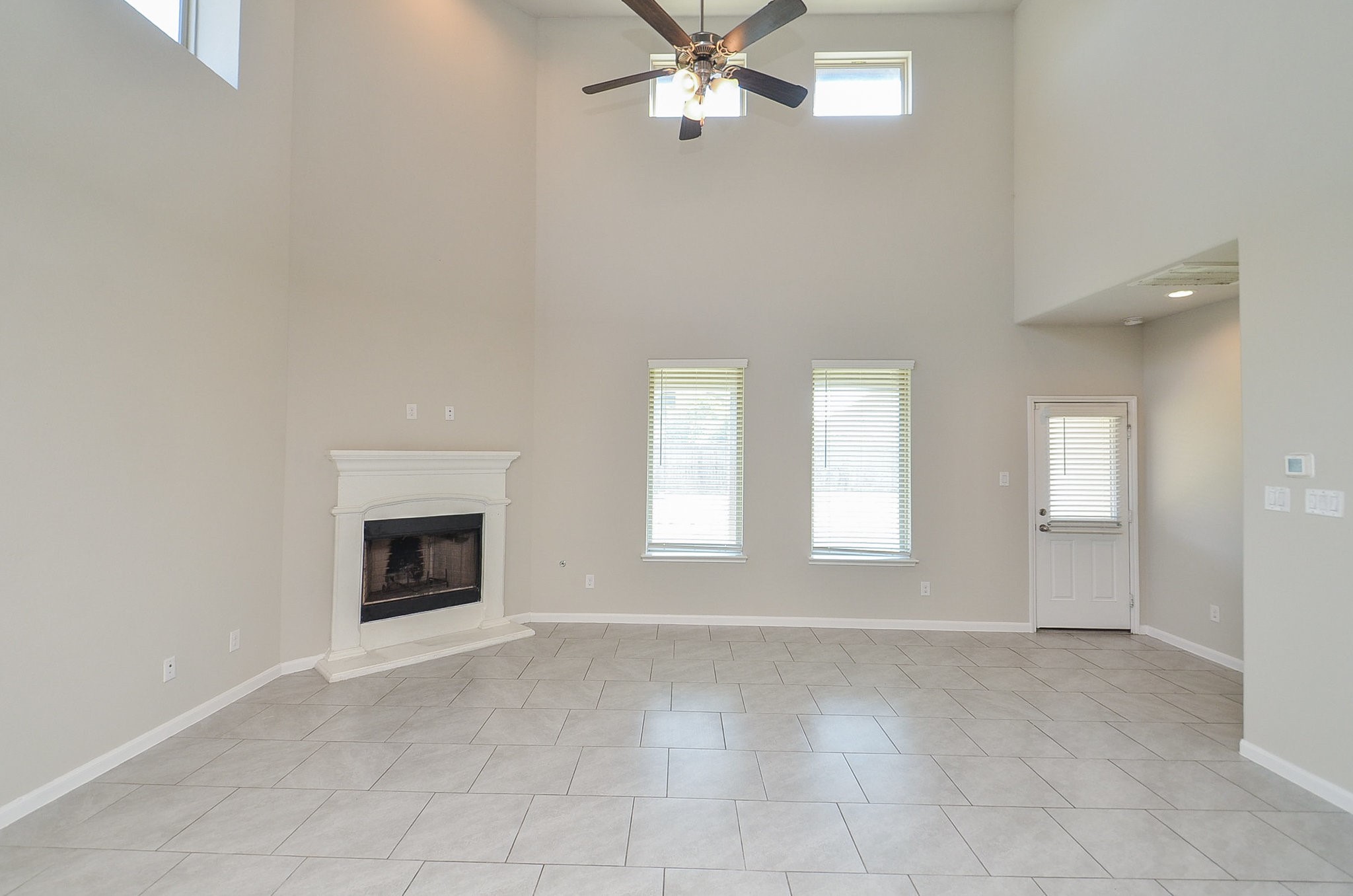 4015 Prairie Landing Lane Katy, TX 77494 - Photo 12 of 32 an empty room with windows and fireplace