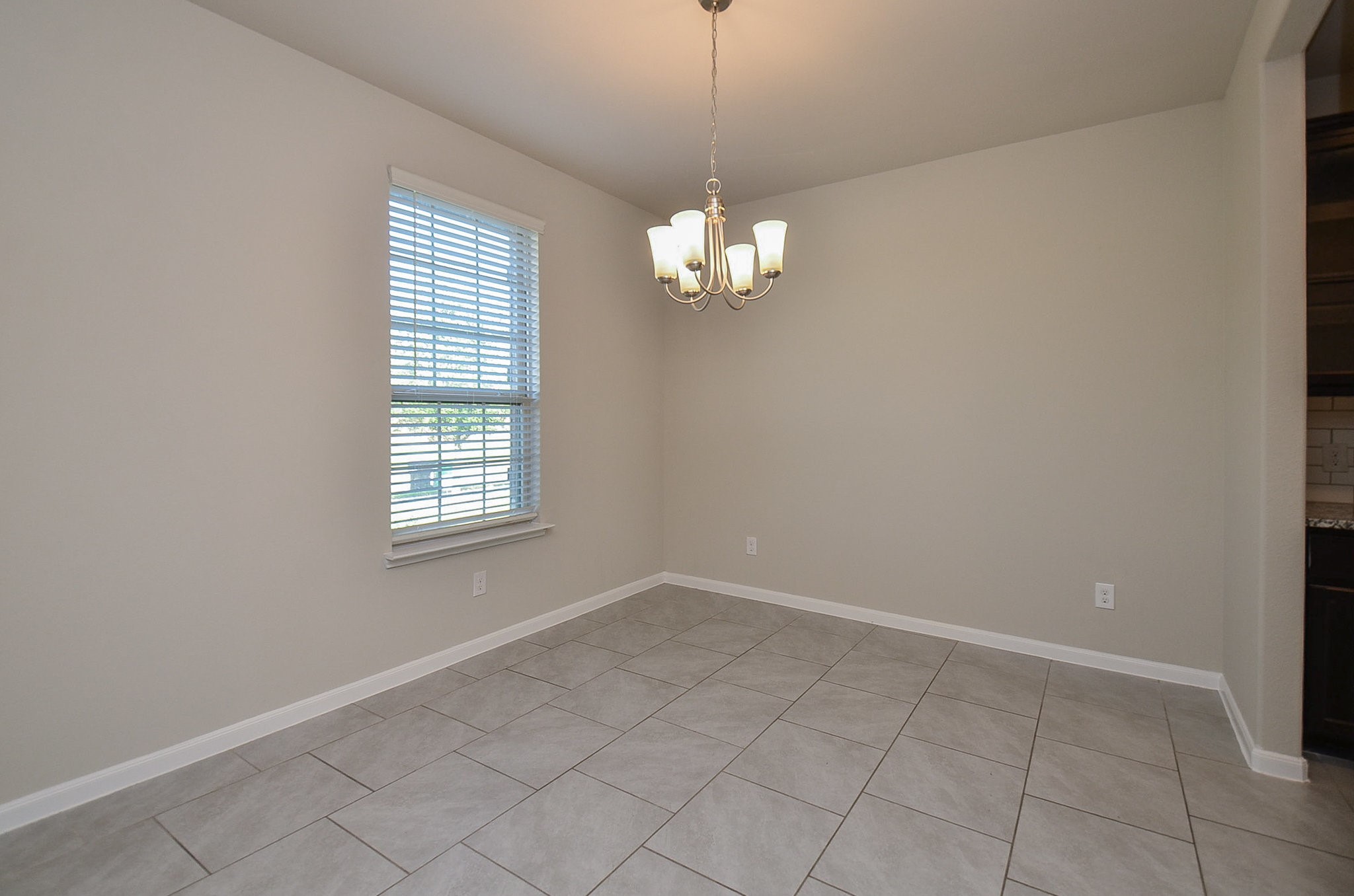 4015 Prairie Landing Lane Katy, TX 77494 - Photo 5 of 32 an empty room with chandelier fan and windows