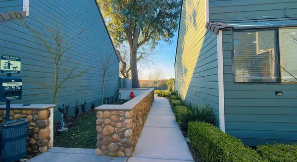 a view of a pathway with a backyard