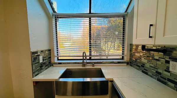 a kitchen that has a sink and a stove