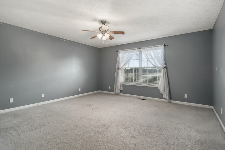 372 Bell Road Morrison, TN 37357 - Photo 22 of 46 an empty room with windows and chandelier fan