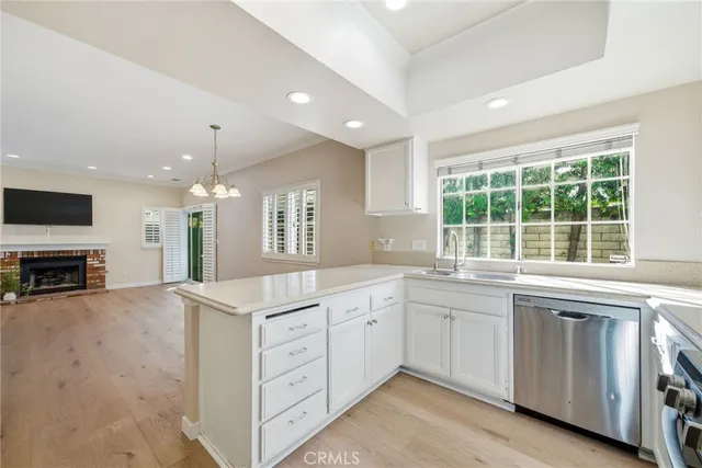 a open kitchen with stainless steel appliances granite countertop a stove and a sink