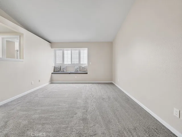 an empty room with a empty space and windows