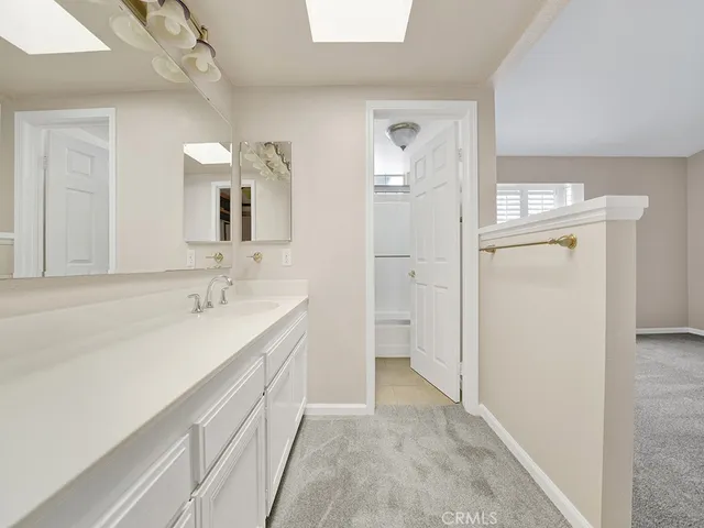 a bathroom with a sink a mirror and a vanity