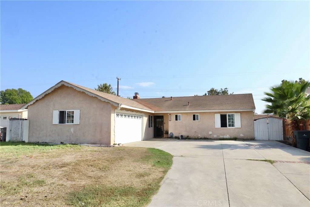 10456 Pendleton Street Riverside, CA 92505 - Photo 1 of 1 a front view of a house with a yard and garage