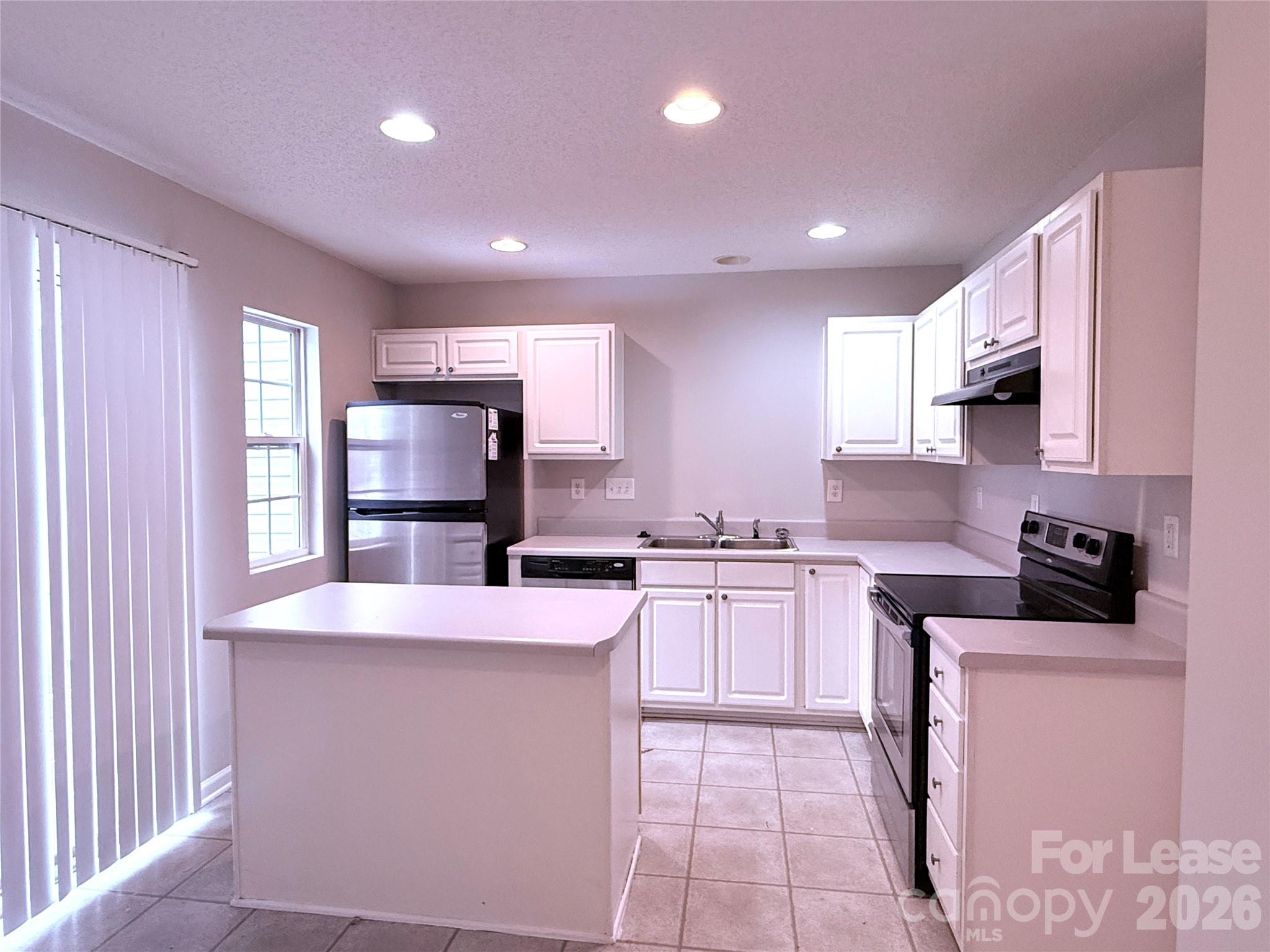 11519 Retriever Way Charlotte, NC 28269 - Photo 6 of 11 a kitchen with stainless steel appliances a sink stove and cabinets