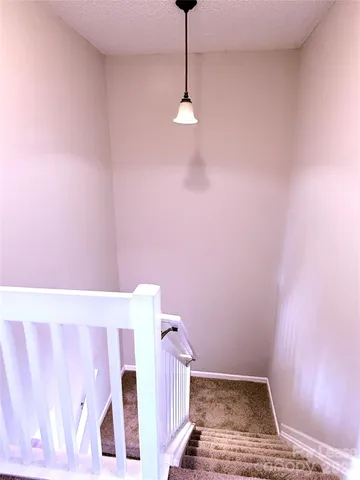a view of a livingroom with wooden floor and a ceiling fan