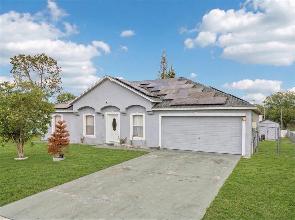 42 Inconnu Drive Poinciana, FL 34759 - Photo 1 of 29 a front view of house with yard and entertaining space