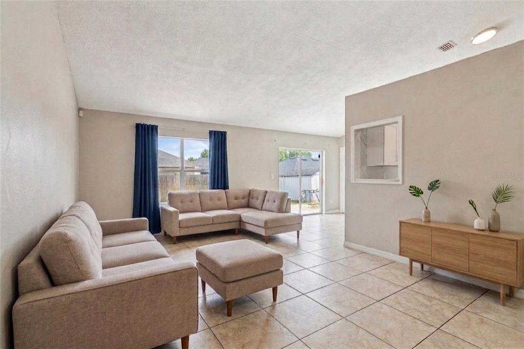 42 Inconnu Drive Poinciana, FL 34759 - Photo 11 of 29 a living room with furniture and a window
