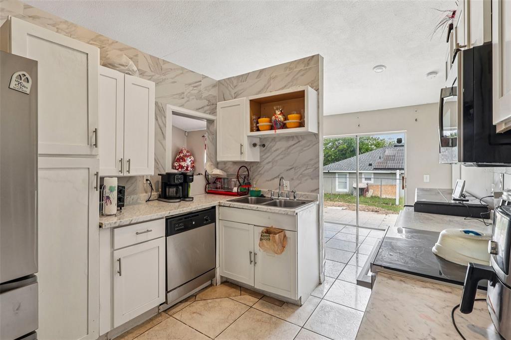 42 Inconnu Drive Poinciana, FL 34759 - Photo 14 of 29 a kitchen with a sink cabinets and wooden floor