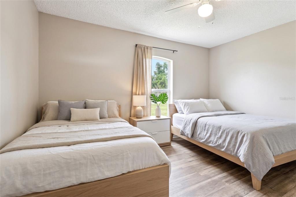 42 Inconnu Drive Poinciana, FL 34759 - Photo 17 of 29 a bedroom with two beds and a large window