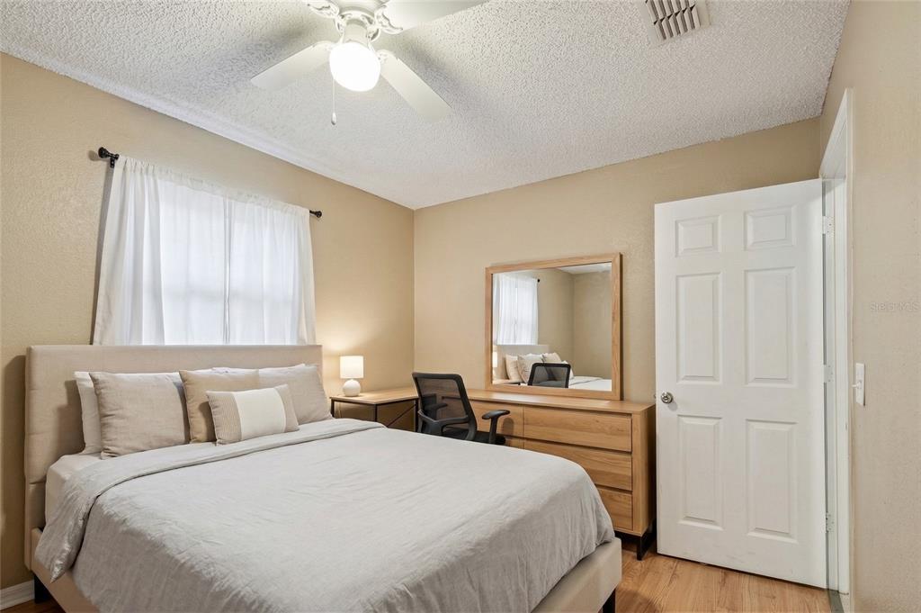42 Inconnu Drive Poinciana, FL 34759 - Photo 19 of 29 a bedroom with a large bed and a chandelier