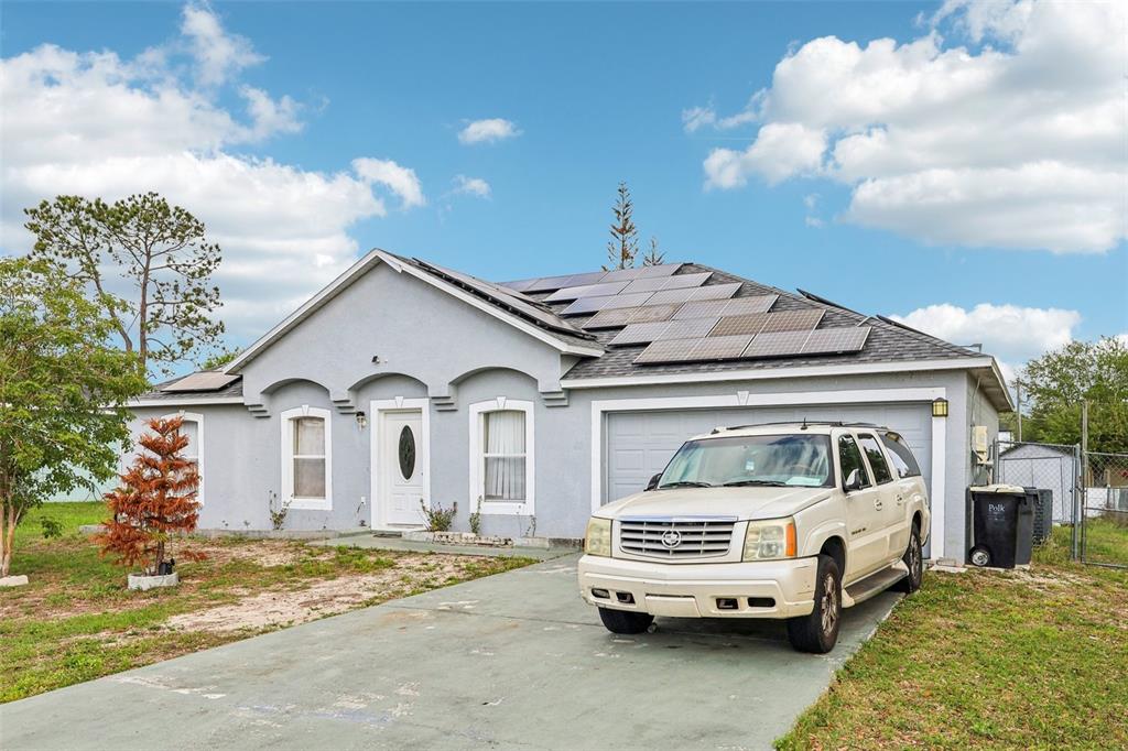 42 Inconnu Drive Poinciana, FL 34759 - Photo 2 of 29 a car parked in front of a house