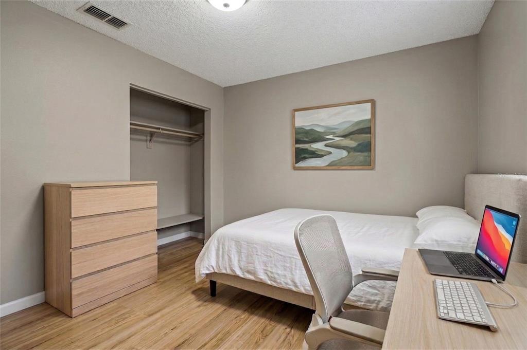 42 Inconnu Drive Poinciana, FL 34759 - Photo 21 of 29 a bedroom with a bed and a chair