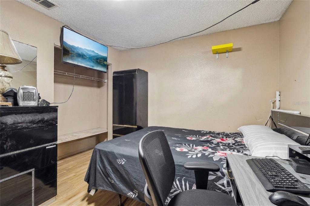42 Inconnu Drive Poinciana, FL 34759 - Photo 22 of 29 a bedroom with a bed and a dresser
