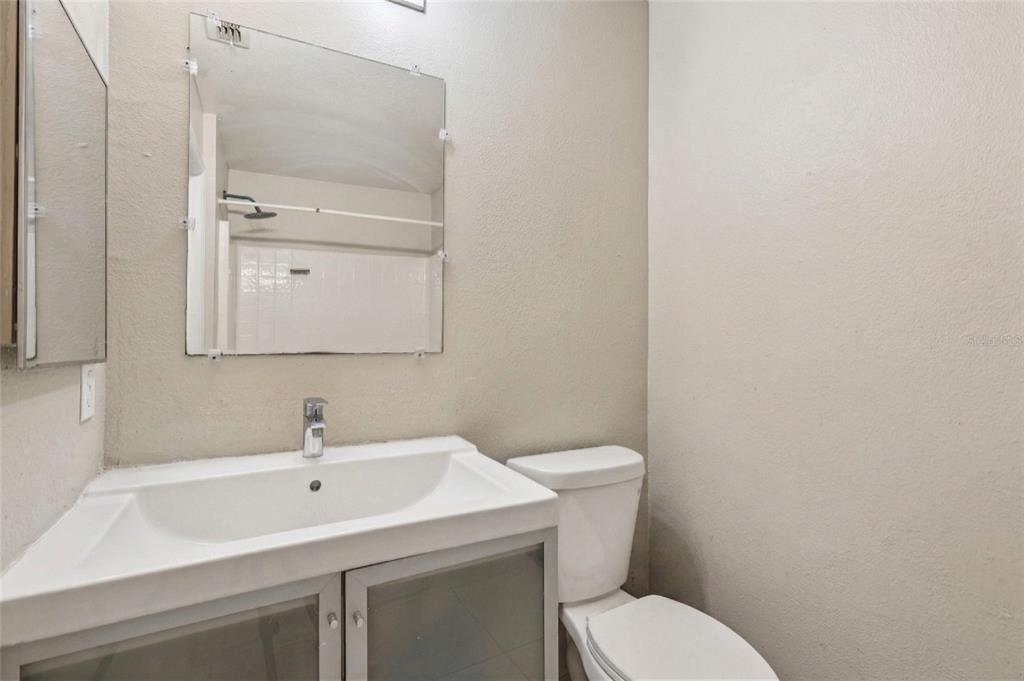 42 Inconnu Drive Poinciana, FL 34759 - Photo 23 of 29 a bathroom with a toilet sink and mirror