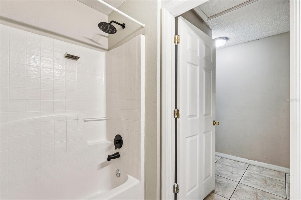 42 Inconnu Drive Poinciana, FL 34759 - Photo 24 of 29 a bathroom with a tub and shower
