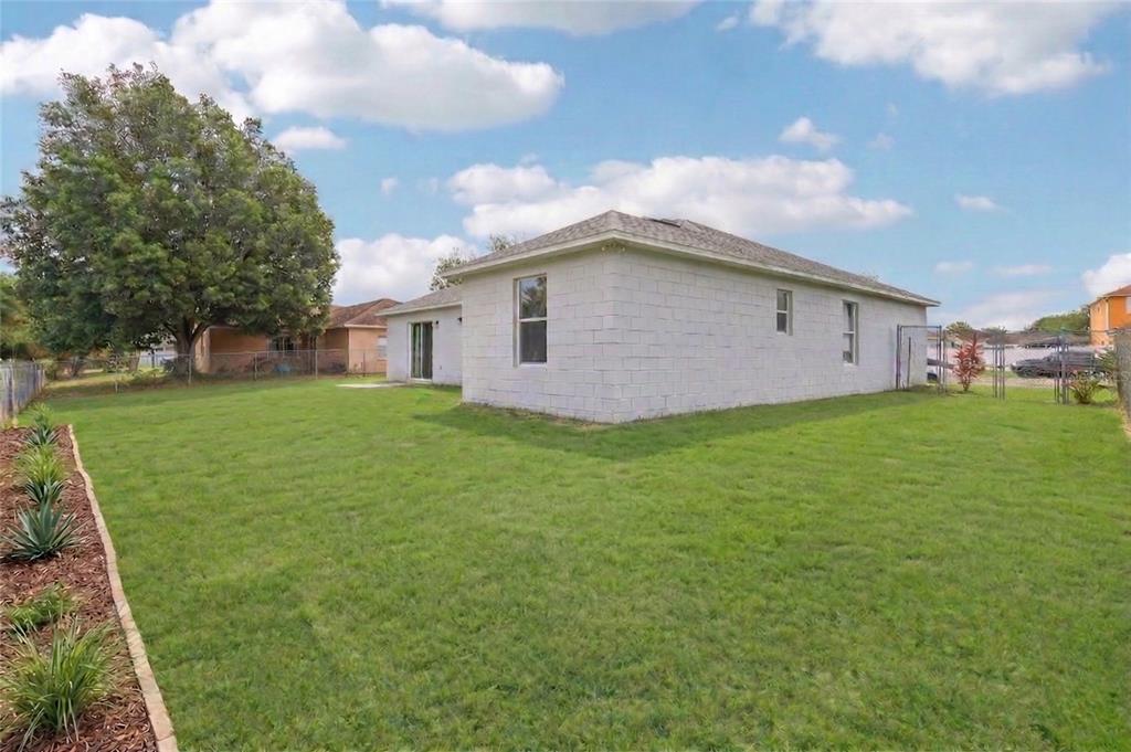 42 Inconnu Drive Poinciana, FL 34759 - Photo 26 of 29 a white house with a yard
