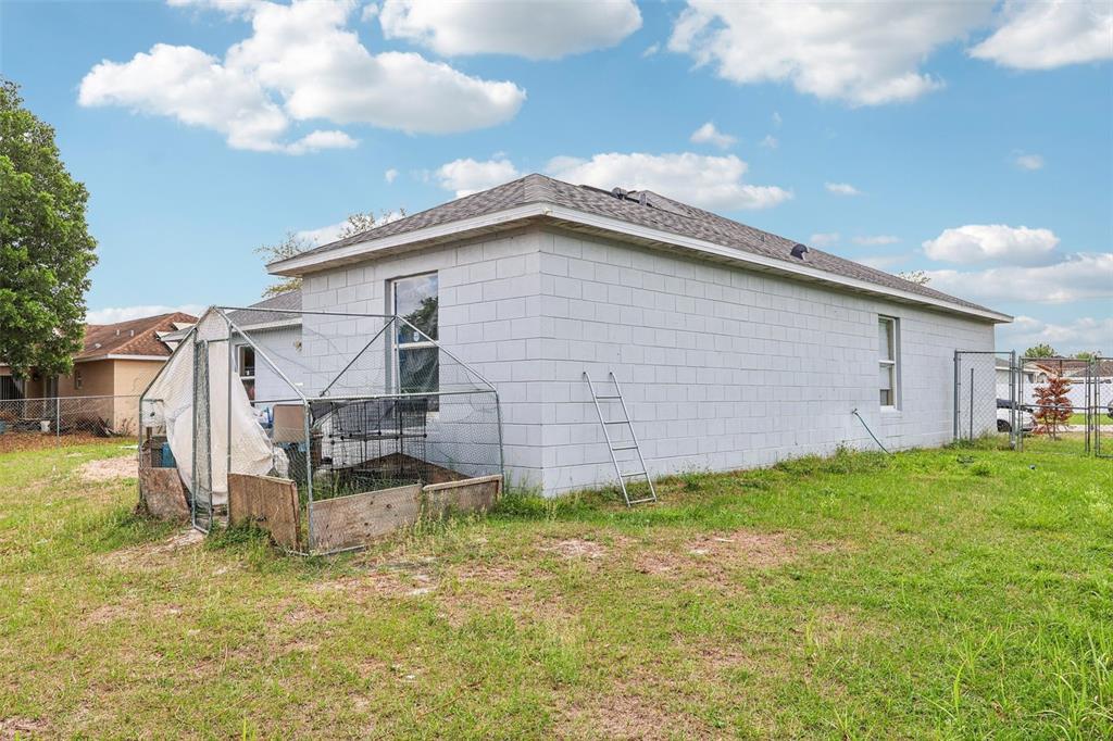 42 Inconnu Drive Poinciana, FL 34759 - Photo 27 of 29 a view of a backyard with plants and a backyard