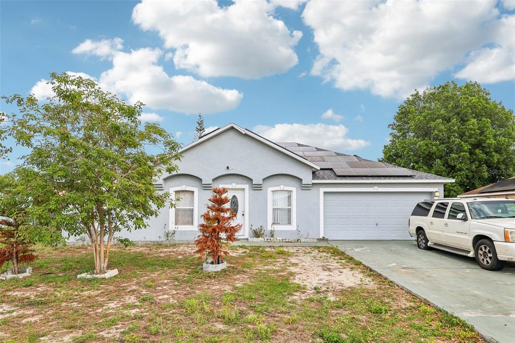 42 Inconnu Drive Poinciana, FL 34759 - Photo 4 of 29 a front view of a house with a yard